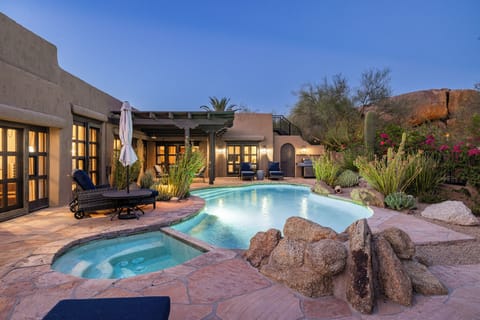 Relax poolside with stunning desert views and a private spa.