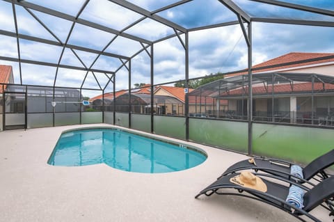 Screened-in pool w/ patio, perfect for a sunny dip or lounging poolside.

