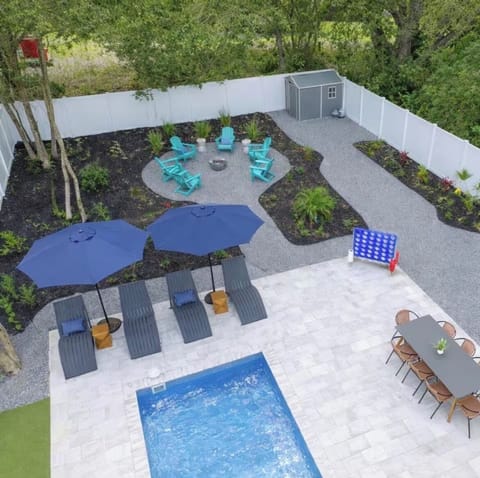 Private pool patio with fire pit lounge, dining area, and fun backyard games