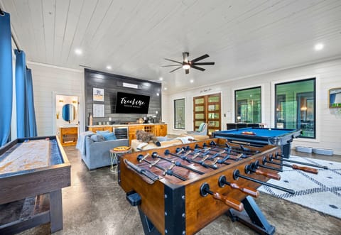 From foosball and pool to relaxing on the couch, there's something for everyone to enjoy in this spacious game room.