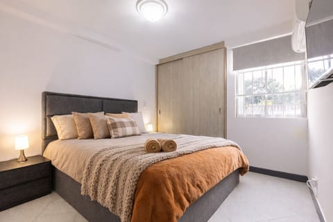 Bedroom with Air Conditioning and TV.