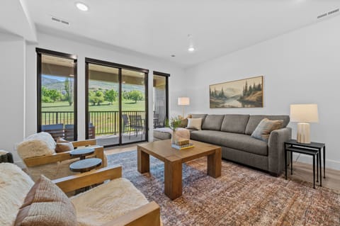 Bright and inviting living room with comfortable seating and mountain views.