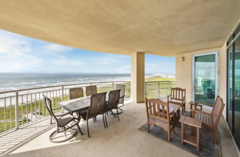 Relax on the expansive covered balcony overlooking the water