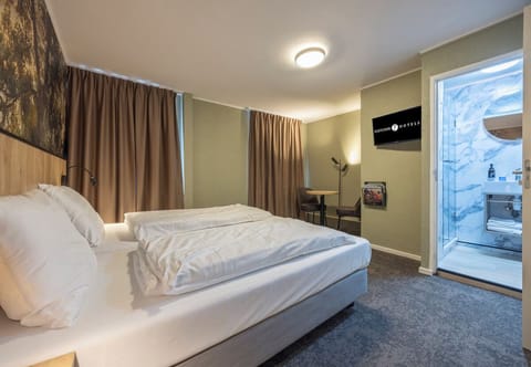 Wake up to soft daylight and a spa-like bathroom nearby.