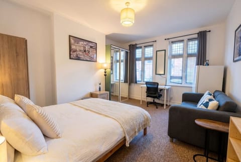 Bright, spacious double with cosy sofa and window desk to settle right in.