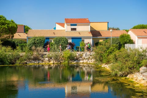 The ornamental pond at the heart of Le Village Club Marin, surrounded by the resort's colourful Mediterranean-style cottages.