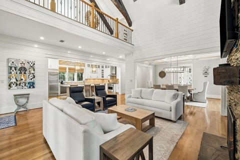 Sink into the plush sofas and feel the warmth of soaring ceilings and natural light filling your elegant open-concept retreat, where every detail invites relaxation.