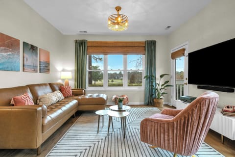 Main Condo’s cozy living room features a beautiful golf course view.