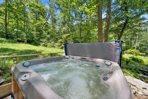 Relaxing hot tub surrounded by the peaceful wooded landscape