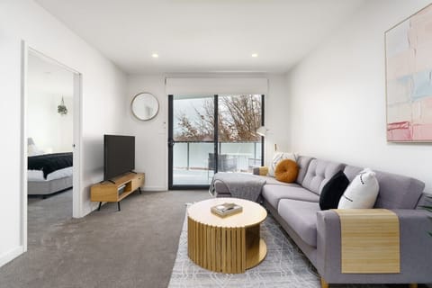 Stretch out on the comfy lounge and unwind in this bright, inviting living space after a day of sightseeing or work.