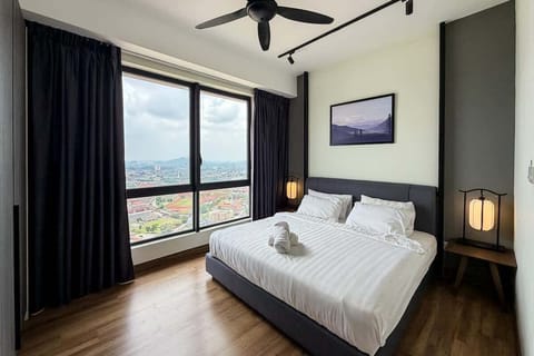 The master bedroom with a king sized bed and an en-suite bathroom.