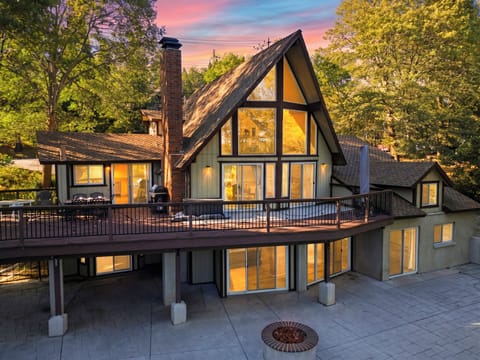Exterior dusk view of the multi-level deck and illuminated cabin.