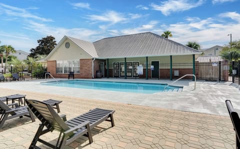 Community pool with lounge chairs, gated for privacy and safety