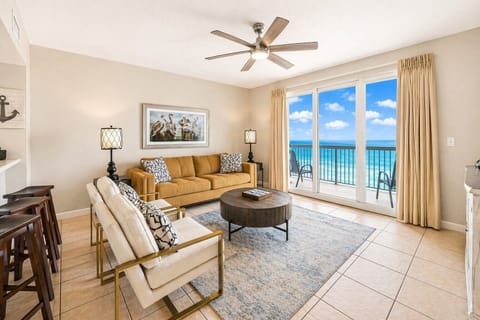 Relax in your bright, open living room with plush seating and breathtaking ocean views through sliding glass doors—your own slice of coastal paradise.
