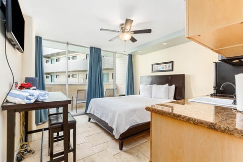 Your bright, modern studio features a plush bed, convenient kitchenette, and private balcony access—perfect for unwinding after exploring the area.