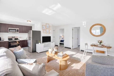 Relax and unwind in the bright living room with comfortable seating, a Smart TV, and plenty of space to gather.
