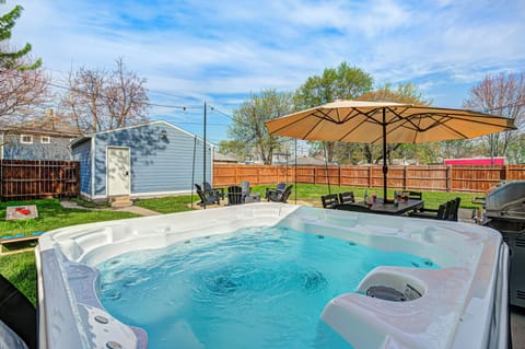 Backyard oasis with hot tub, fire pit, grill, dining area & yard games