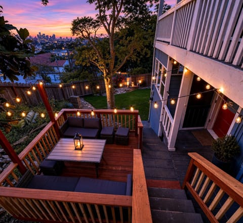 Cozy string-lit deck with skyline views and spacious yard