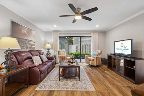 A Smart TV, ceiling fan overhead, and sliding doors to the patio make this the perfect spot to unwind however you like, movie night or island breeze, take your pick