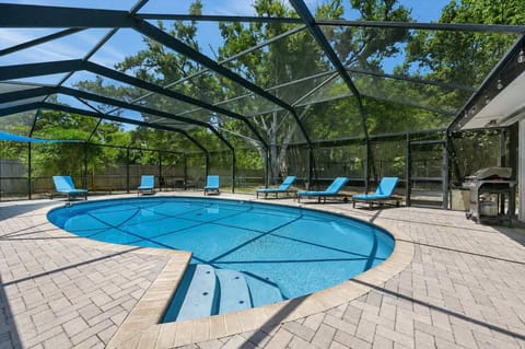 Screened pool with expansive paver deck