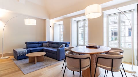 Step into a spacious living area where a comfortable sectional sofa invites relaxation after a day of exploration, perfectly paired with a stylish dining table ready for shared meals and memorable conversations. Flooded with natural light from elegant win