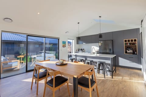 Bright modern kitchen-dining space with seamless indoor-outdoor flow