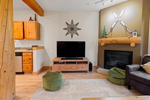 This cozy living space combines a flat-screen TV and a fireplace, creating the perfect setting for evening relaxation after a day of outdoor adventures.