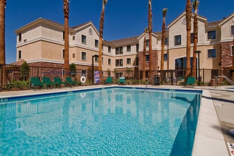 Poolside seating with shaded umbrellas and sun loungers.