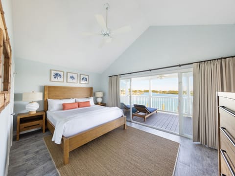 Awake to breathtaking views in this sunlit master bedroom, where comfort meets coastal charm—the perfect haven for relaxation.