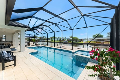 Large outdoor riverfront patio with lanai, heated pool, and spa-like hot tub!