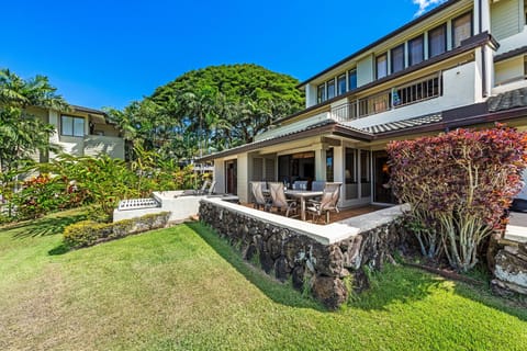 Spacious golf villa with a private lanai, lush lawn, and fairway views.