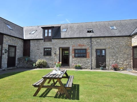 View towards the stone barn with shared lawn and picnic area