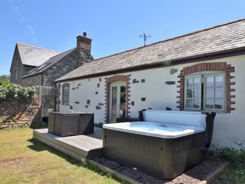 Take in the amazing views out to sea from the private hot tub set in the enclosed garden