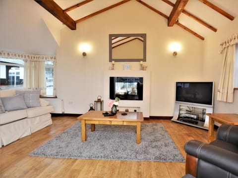 Relax in the lounge with pebble effect electric fire, comfortable seating and Sky TV