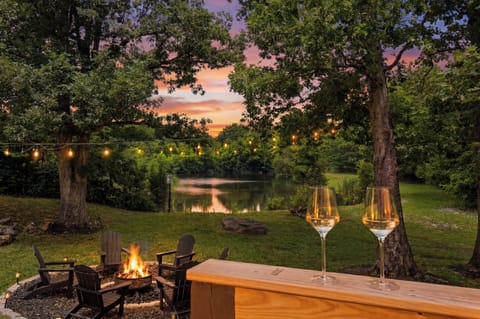 Lakeside fire pit, string lights, and sunset views for cozy evenings
