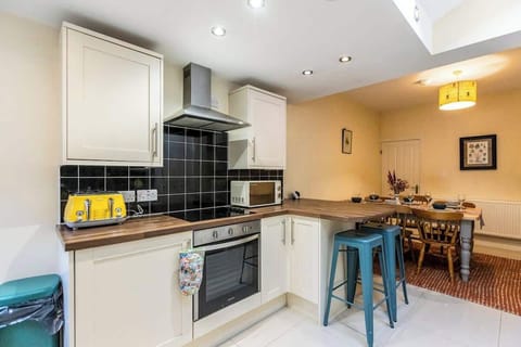Fully equipped kitchen with modern appliances and a skylight that floods the space with natural light — perfect for cooking and socialising
