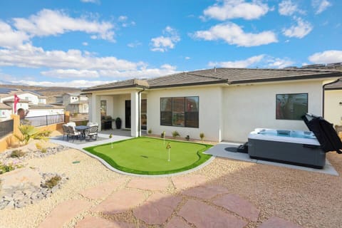Private backyard retreat with a hot tub, putting green, outdoor dining and BBQ grill - perfect for relaxing or entertaining!
