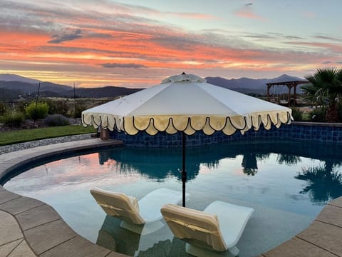 Golden hour at Sunset Vista Escape. Unwind in the resort-style pool while taking in panoramic views of the Shasta Ballys, Trinity Alps, and some of Redding`s most spectacular sunsets