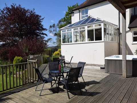 Decked area with hot tub, BBQ lodge and seating