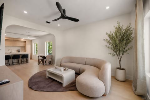 Bright modern lounge with designer seating and open-concept kitchen