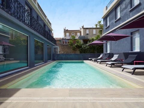 Seasonal outdoor pool, open 9:00 AM to 8:00 PM, pool umbrellas