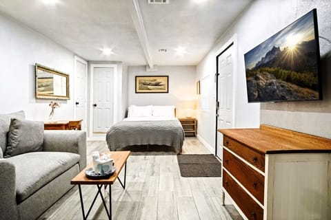 Queen bed in the main room — writing desk nearby for work or study.