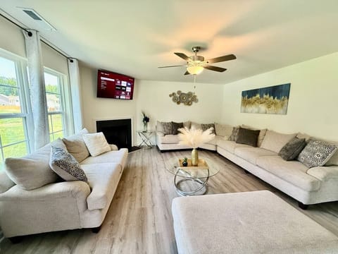 Large living room with multiple seating and smart tv
