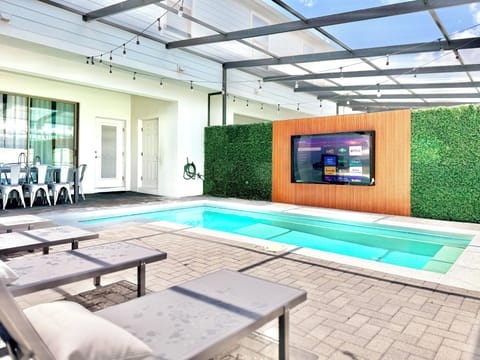 Swim and watch TV by the private pool with outdoor Smart TV & loungers. outside