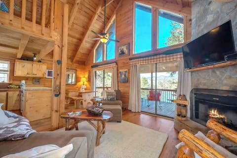 Huge lake and mountains views from living room/kitchen area. Wrap around, gated deck. No steps to enter main level of cabin. The main level has 2 bedrooms, kitchen, fill bath and upper deck.