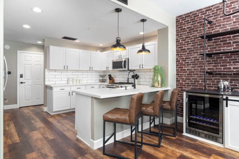 Fully stocked kitchen with premium appliances including gas cooktop, dual ovens, dual ice makers, and wine fridge too. 