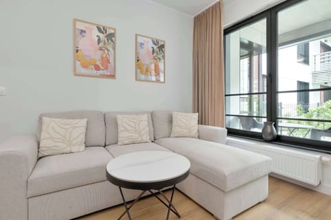 Relax in the stylish living room with a comfortable sofa and modern decor.