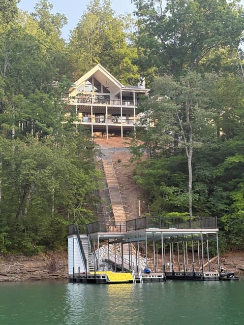 Back of the home with beautifully finished lake access stairs and a private tram