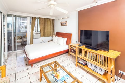 Unwind in your bright bedroom with a plush bed and private balcony overlooking the city. Enjoy your favorite shows on the flat-screen TV while the ceiling fan keeps you cool.