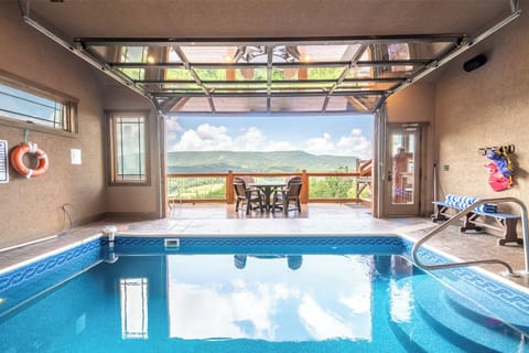 Dive into your private indoor pool and soak in stunning mountain vistas. The glass garage door opens to a deck where you can dine al fresco surrounded by natural beauty.